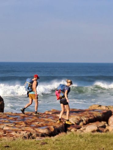 Rock-hopping along the flat rock shelf near Luphuthana.