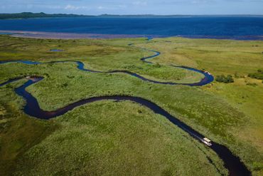 The 3 Lakes Boat charter putters through meandering channels from first lake across to third.