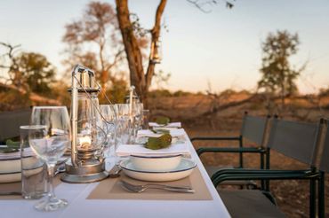 A bush-elegant dining table is set up for dinner every night.